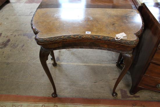 Walnut foliate scroll-carved card table, with shaped baize-lined top